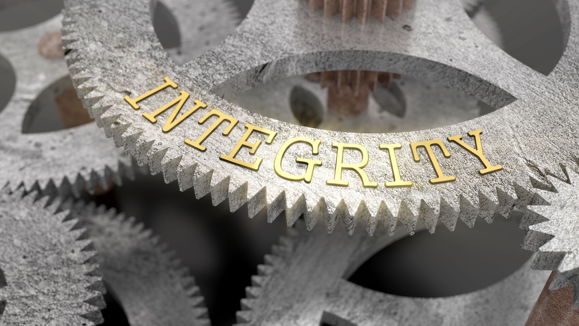 The inscription INTEGRITY on the gear of the clock mechanism
